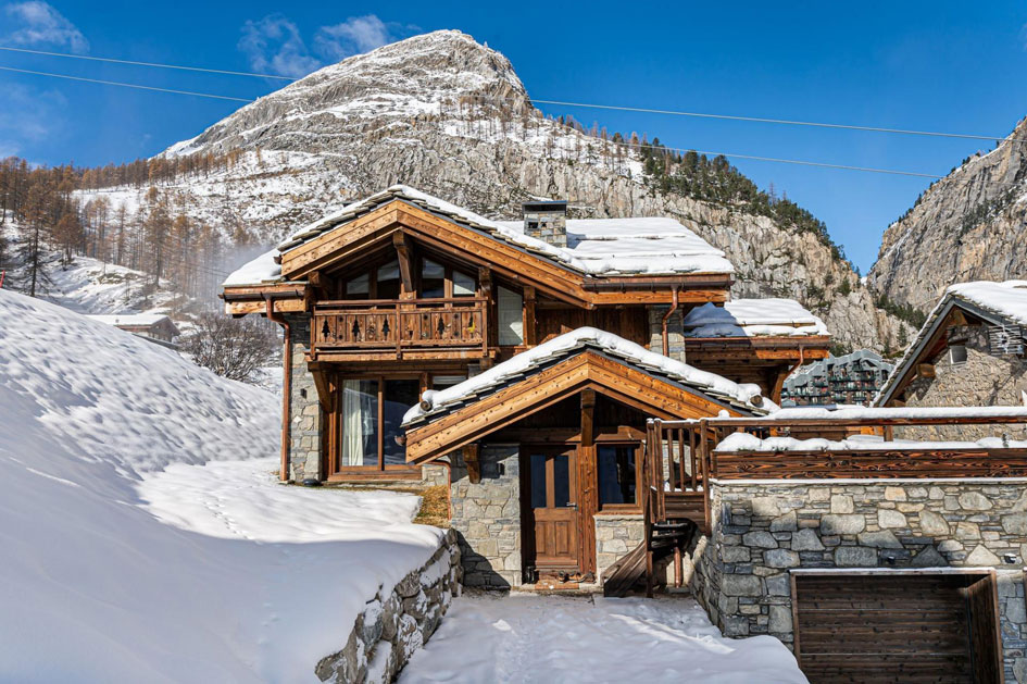 Chalet Saint Joseph in Val d'Isere features a beautiful stone and wooden exterior that's reminiscent of a mountain home in the French Alps. It's ski in, ski out access also makes it a great option following a day of après-ski at La Folie Douce!