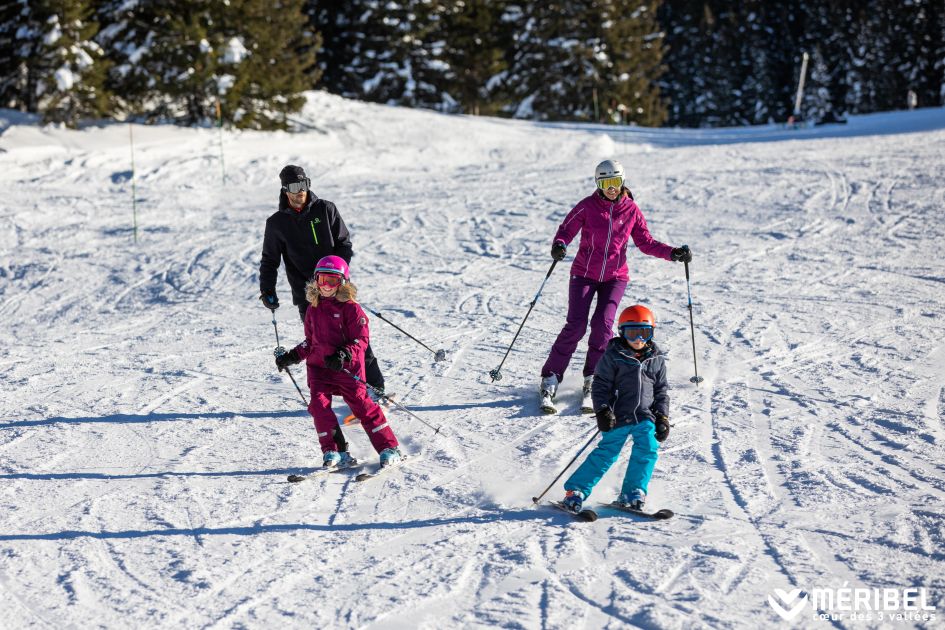 Beginner skiers. Photo Credit: Sylvain Aymoz A family skiing in Méribel, one of our picks for best ski resorts for beginners.