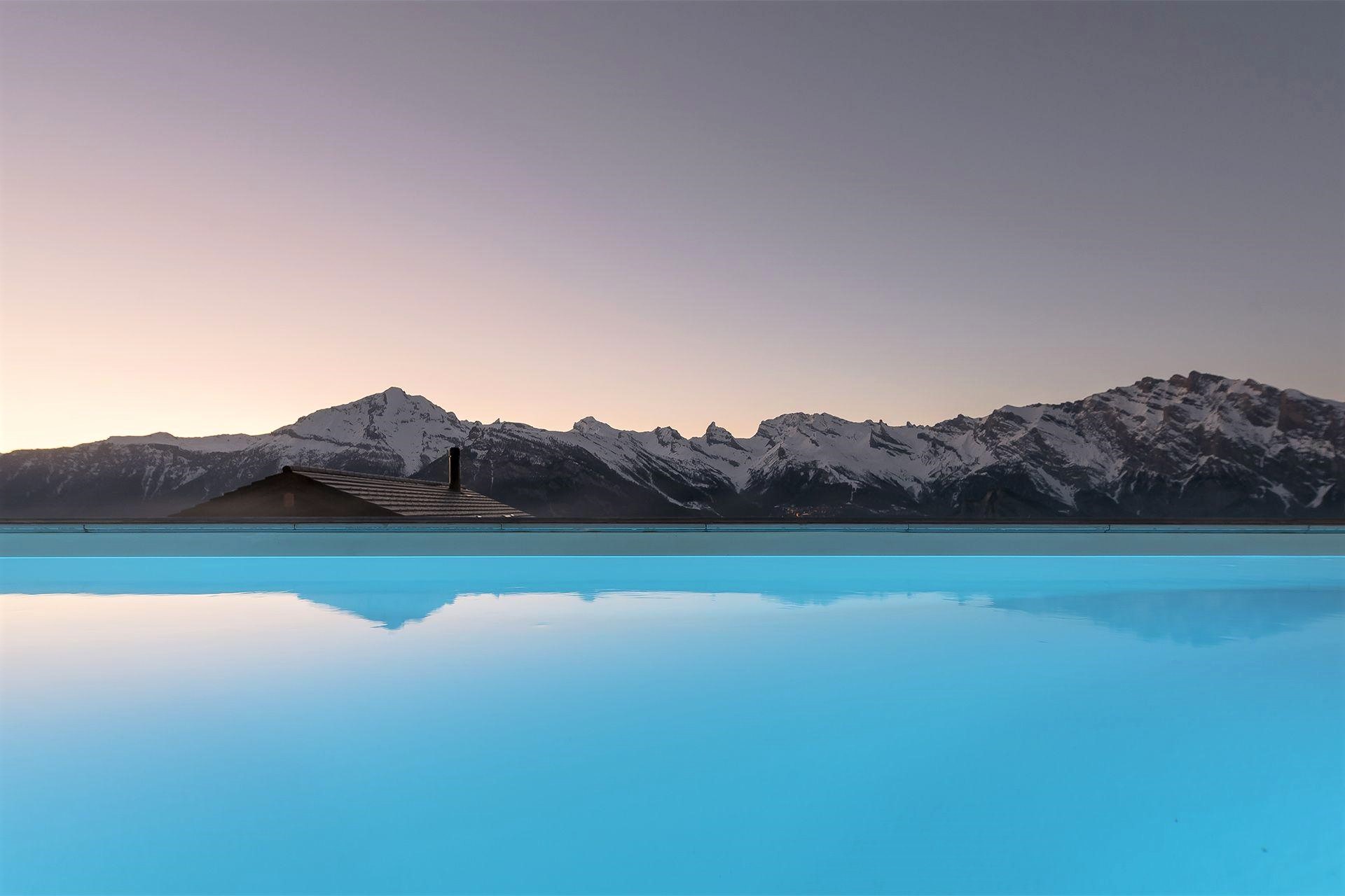 Chalet V, La Tzoumaz Close up image of the luxurious outdoor swimming pool, overlooking the breathtaking mountain views ahead.