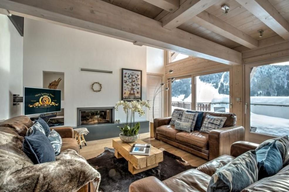 Living space with fireplace and mountain views at Morzine self catered skii chalet