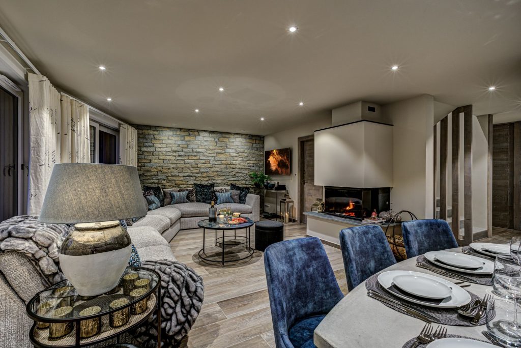Chalet d'Espoir, Morzine. Living space with dining table and fireplace at luxury self catered chalet in Morzine