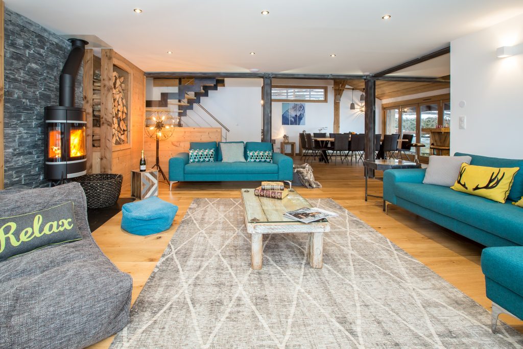 Chalet Lumina, Morzine. Large living room with open plan and logo burner at luxury self catered ski chalet in Morzine