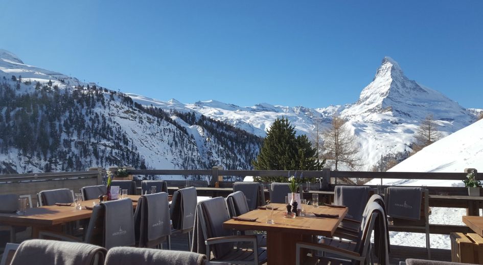 The outdoor terrace at Adler Hitta restaurant in Zermatt with a Matterhorn view, perfect to experience whilst on a luxury self catered ski holiday in Zermatt 