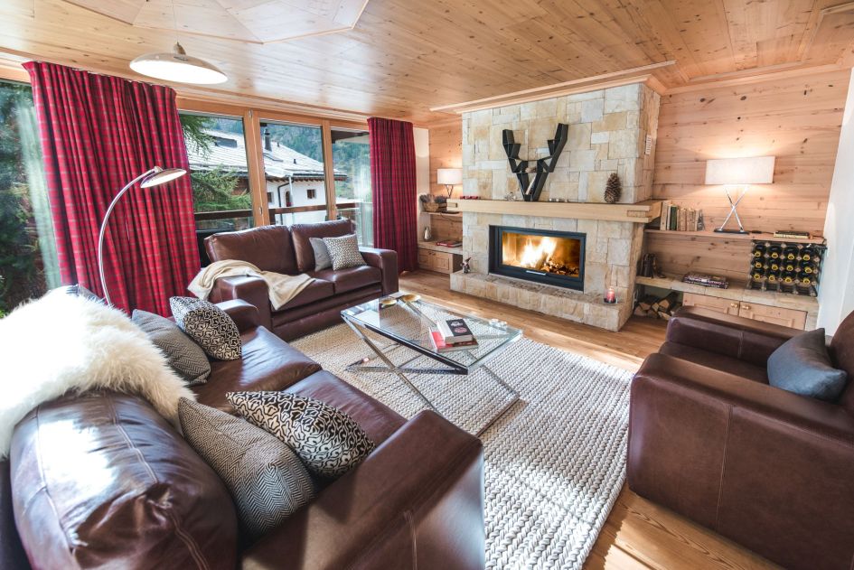 Living room with fireplace at Chalet d'Amore for the perfect cosy setting on a luxury self catered ski holiday in Zermatt