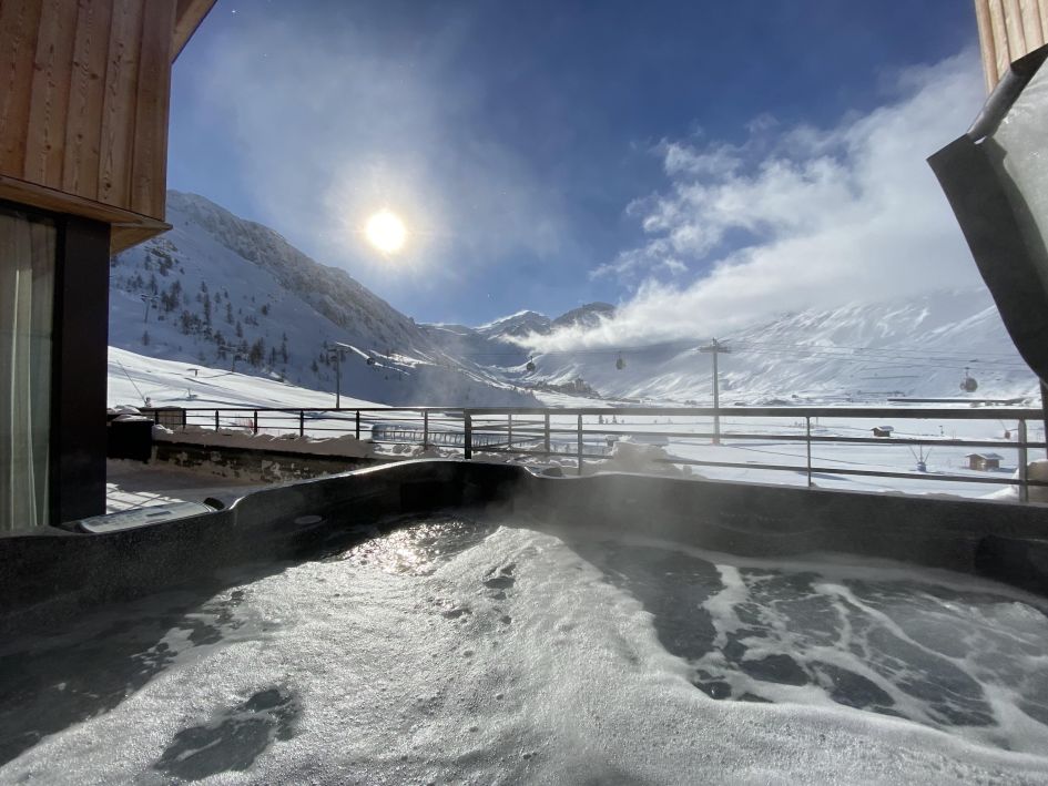 Apartment Tajj The outdoor hot tub, balcony and views at the ski in ski out Apartment Tajj in Tignes Le Lac.