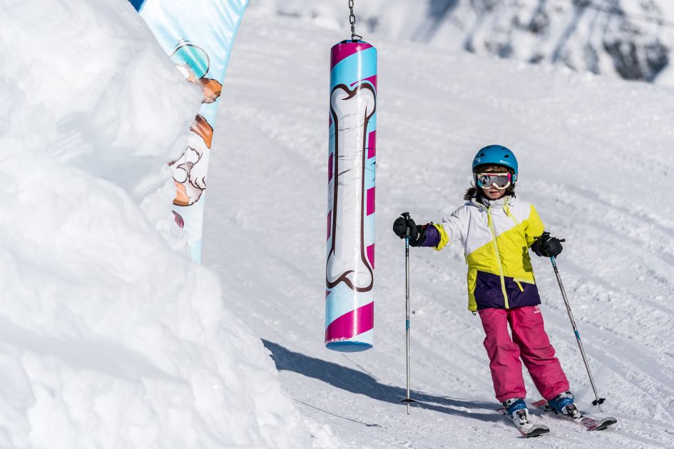 A child skiing through a fun park in La Rosière, a great ski resort for beginners.