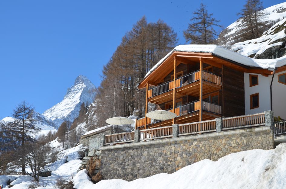 Chalet Gemini with the Matterhorn in the background, in the luxury resort of Zermatt, a great resort for early season skiing. 
