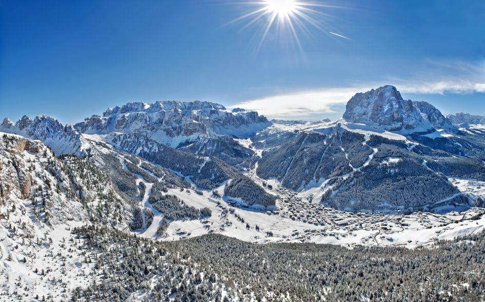 An aerial view of Selva Val Gardena ski resort and the surrounding Dolomite peaks.