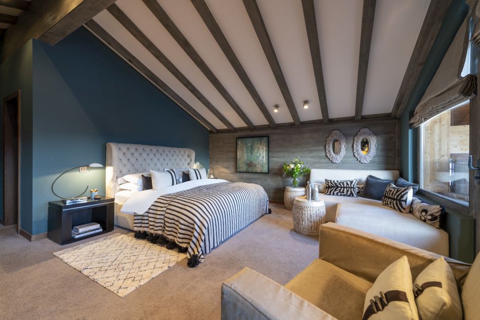 Luxury catered ski chalet in the Swiss Alps with a spacious master bedroom.