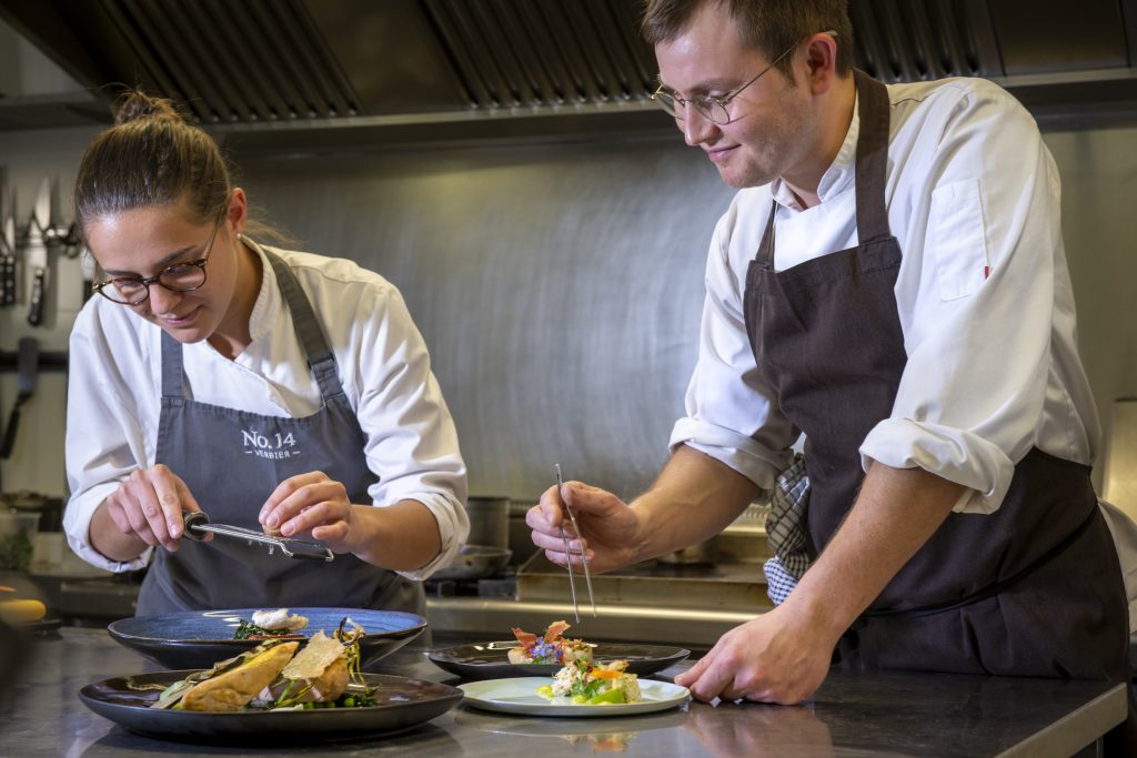 Two chefs of Chalet No 14 in Verbier creating stunning gourmet meals for a luxury catered ski holiday in Switzerland.