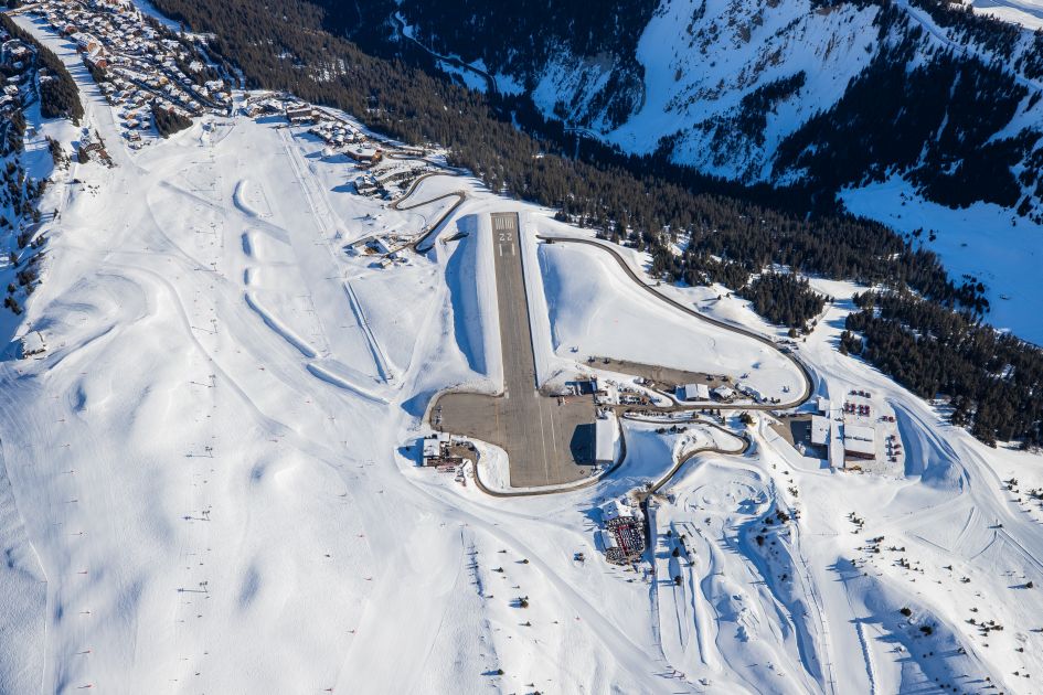 An aerial view of the altiport and Pralong piste, a blue/green run in Courchevel 1850 with ski in ski out chalets at the bottom. 