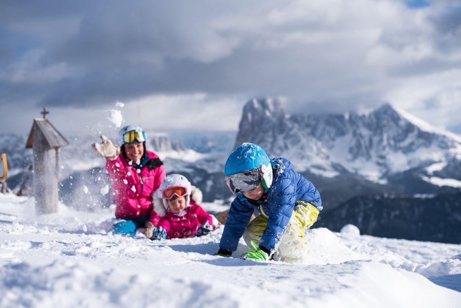 Family fun playing in the snow. There are plenty of things to do on a luxury family ski holiday in Selva Val Gardena.