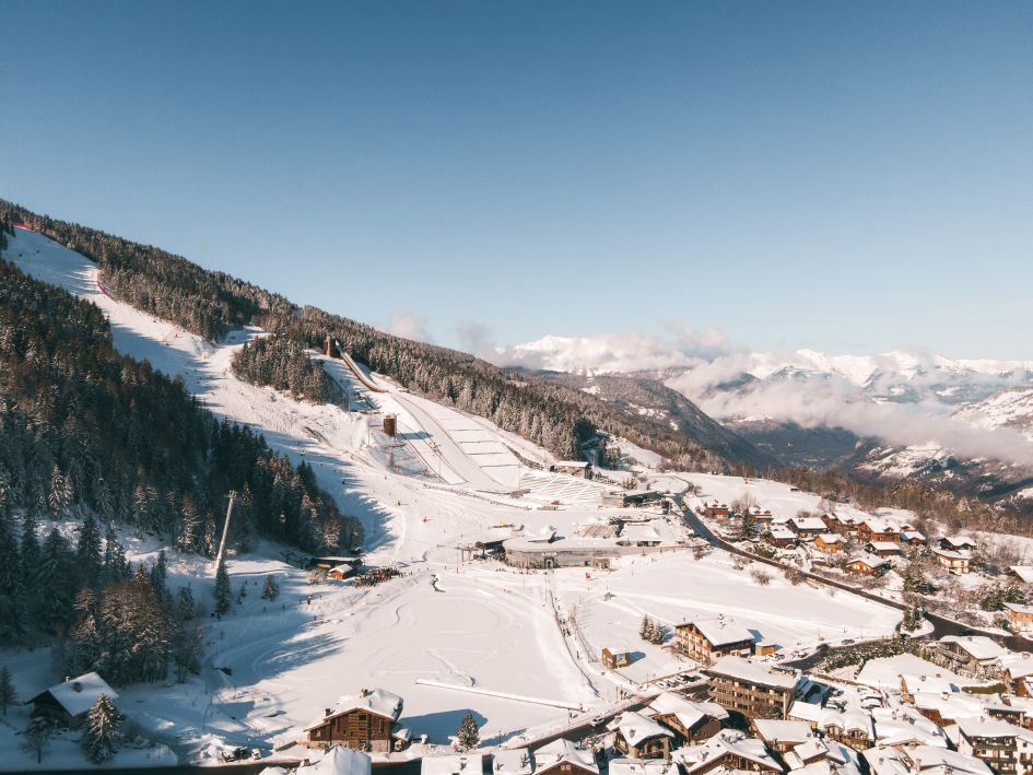 Capture of Courchevel Le Praz village featuring the ski jump, cross-country ski track, Alpinium building and chocolate box chalets