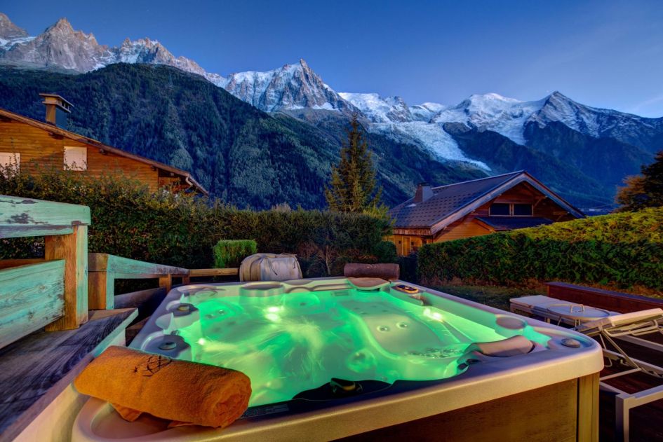 Chalet Solaire's outdoor hot tub in view of the mountains is the place to retreat to following an afternoon's après-ski!