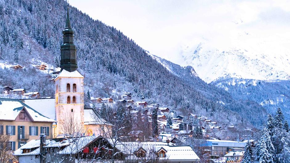 The luxury ski resort of Saint-Gervais, near the Mont Blanc massif. Showing the charming church and snowing hills.