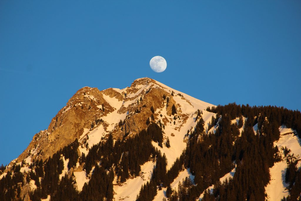 Near full moon over the mountains in Morzine.