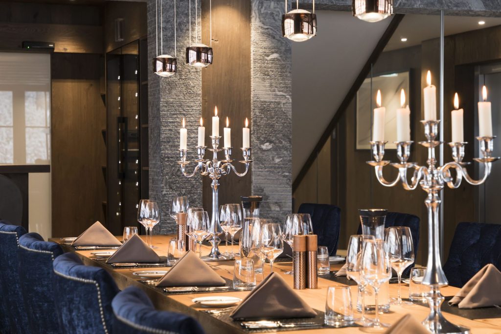 Dining table of Chalet Lena in St Anton, complete with candelabras and ready for a meal.