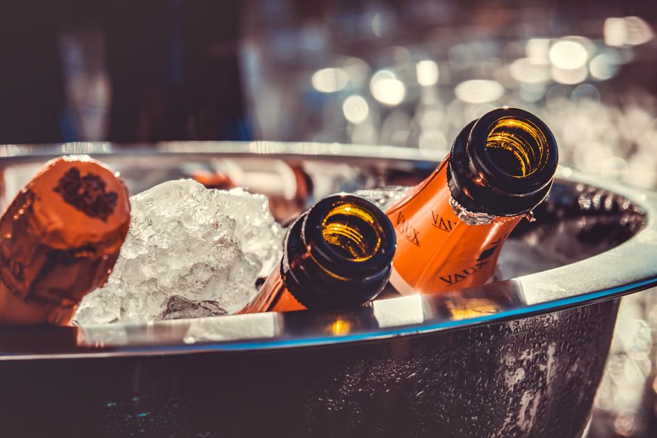 Bottles of prosecco and champagne in a silver ice bucket.