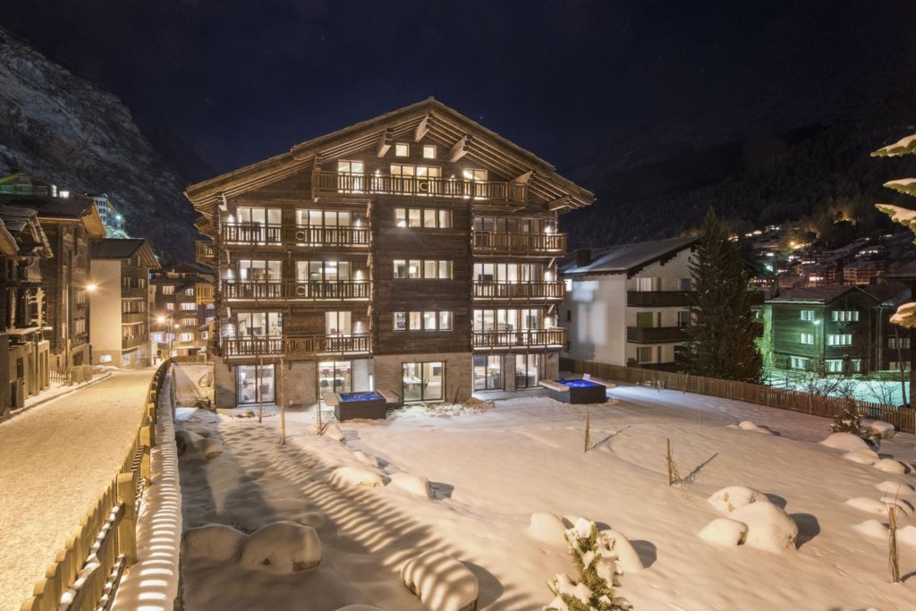 Nighttime exterior of Christiana, one of the top ski holiday residences in Zermatt.