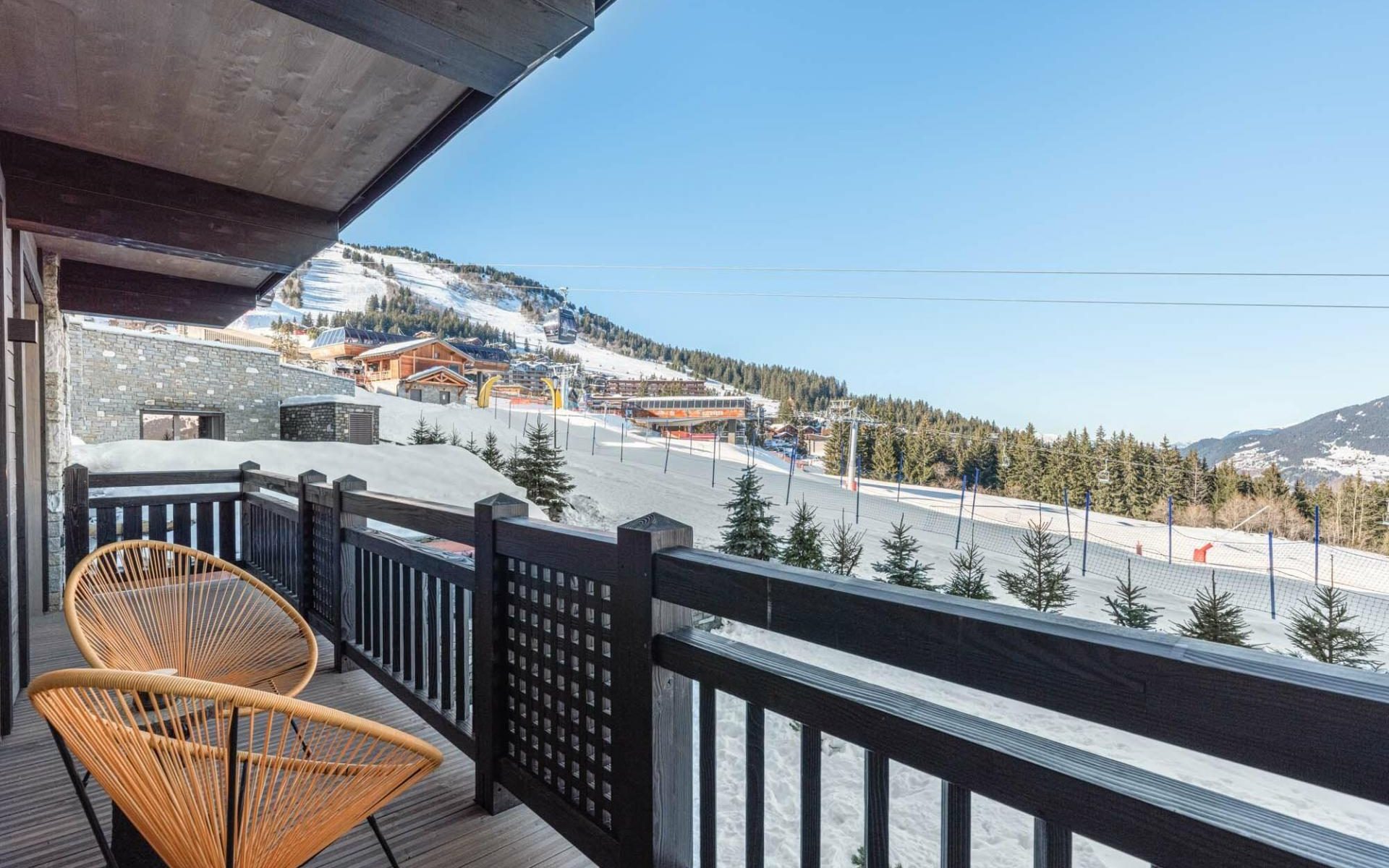 Balcony with a view of the slopes at Mascara Residences in Courchevel.