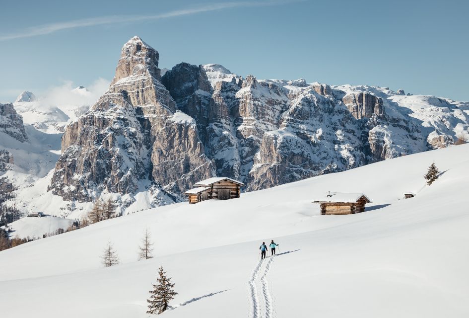 Alta Badia. Credit: Alex Moling Show shoeing in Alta Badia, dramatic landscape in the background and untouched snow surrounding mountain huts.