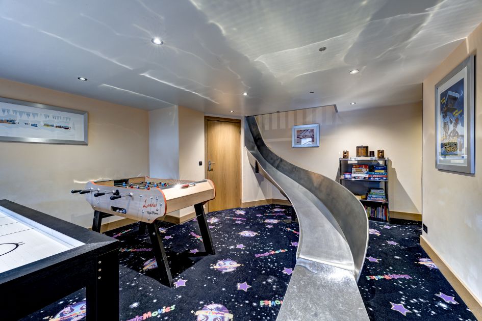 Games room with an air hockey table, table football with slide leading from floor above, an incredible facility for a family ski holiday!