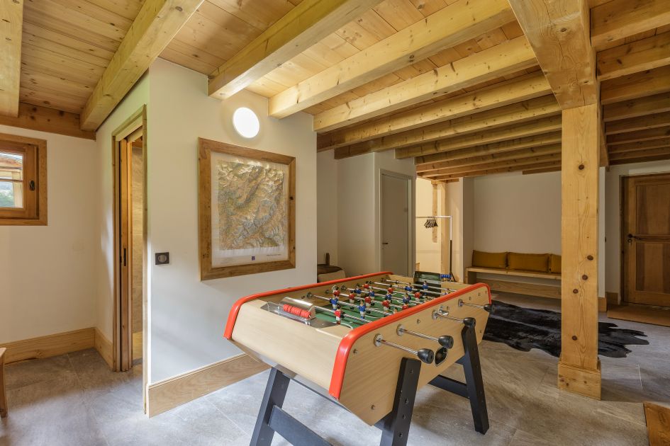 Table football in Chalet Valhalla, wooden beams above.