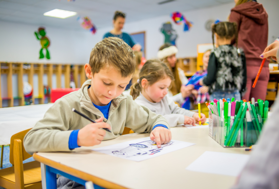 Village of Aiglons. Credit: Andy Parant via Val d'Isère Tourism A child colouring in during a session at a play centre in Val d'Isère,