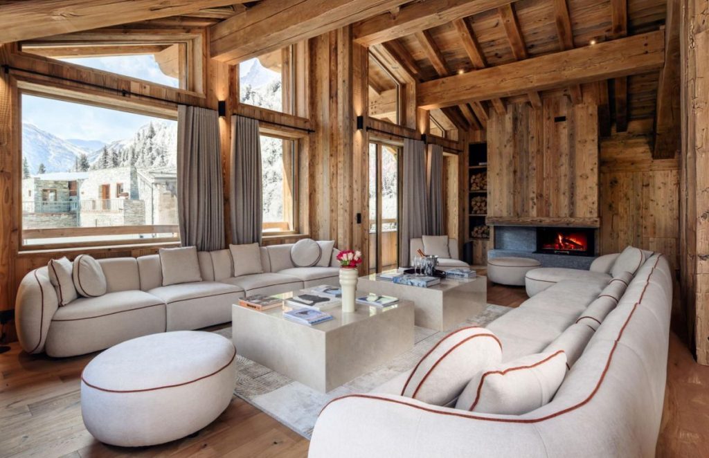 Chalet Cervinia, Val d'Isère New luxury chalet in Val d'Isère featuring the convivial lounge area with stylish cream sofas, an open fire and mountain view.