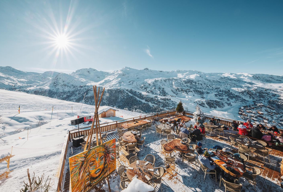 The terrace at Le Tipi Meribel with stunning views of the mountains and pistes accentuated by the bluebird day sunshine 