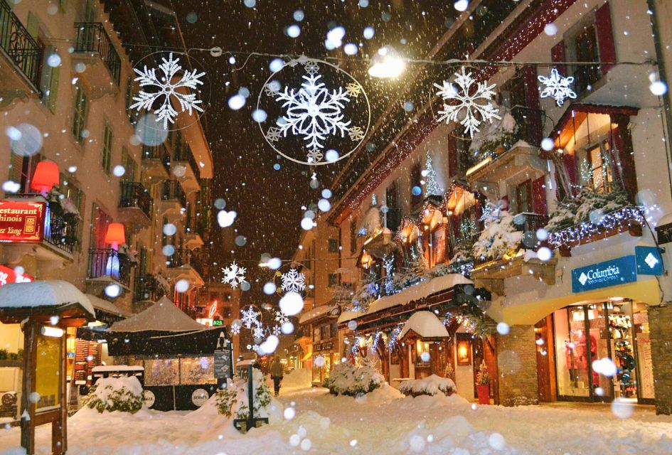 Snowy Streets in Chamonix-Mont-Blanc - Ilaria Menchini Winter scene in Chamonix with the snow falling and Christmas lights twinkling. Snow is on the ground and shop windows looking cosy.