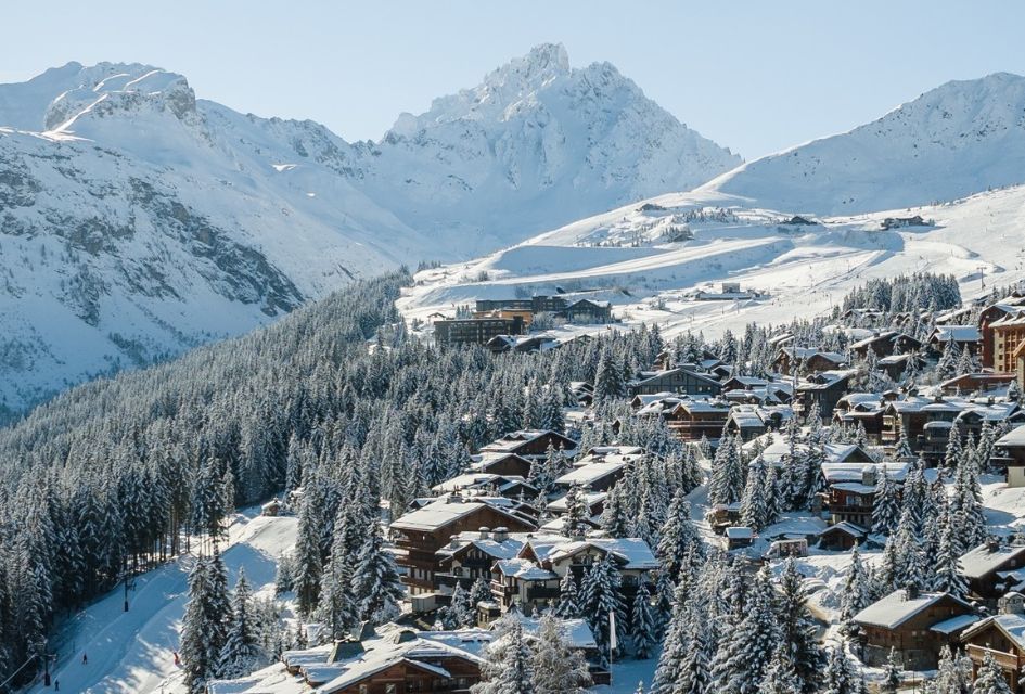 Credit: Courchevel Tourism Courchevel in the 3 Valleys. Showcasing tree lined ski runs, snowcovered chalets amd majestic peaks in the background.