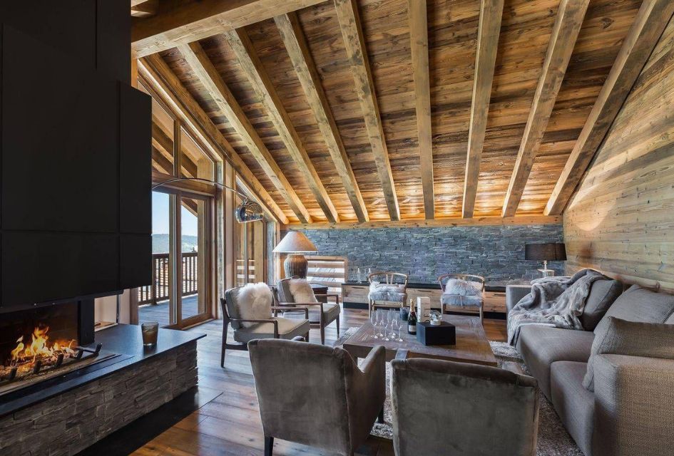 Les Belles Alpes 4, Méribel Plush, comfortable sofas surrounded in a blond wood interior with vaulted ceilings and a roaring wood-burning fireplace in Les Belles Alpes 4.
