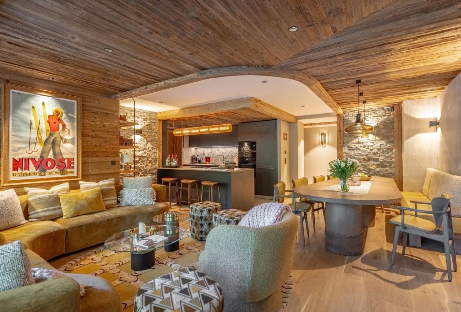 Apartment Serene, Méribel Open-plan living space showcasing fun and quirky interiors around sumptuous sofas, bar area and dining table. It's unique style makes this proeprty one of our top luxury ski apartments in Méribel