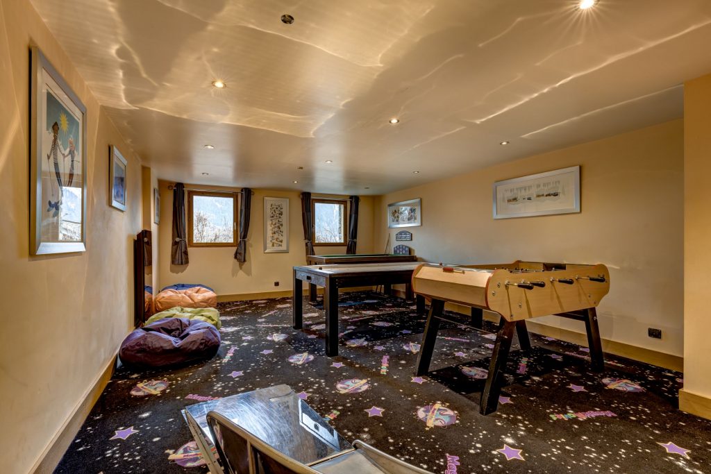 Chalet Serena, Chamonix Chalet Serena's indoor games room, featuring a wooden foosball table and a pool table.